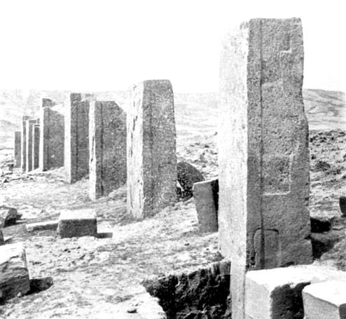 Photograph of one of Posnansky's excavations at the Kalasasaya, Tiwanaku. Although there is a retaining wall between the megaliths, its height reaches only to the level of the ground. Note also the regular and shallow indentations on the side of the nearest megalith, which may indicate the use of a stone-softening technology.